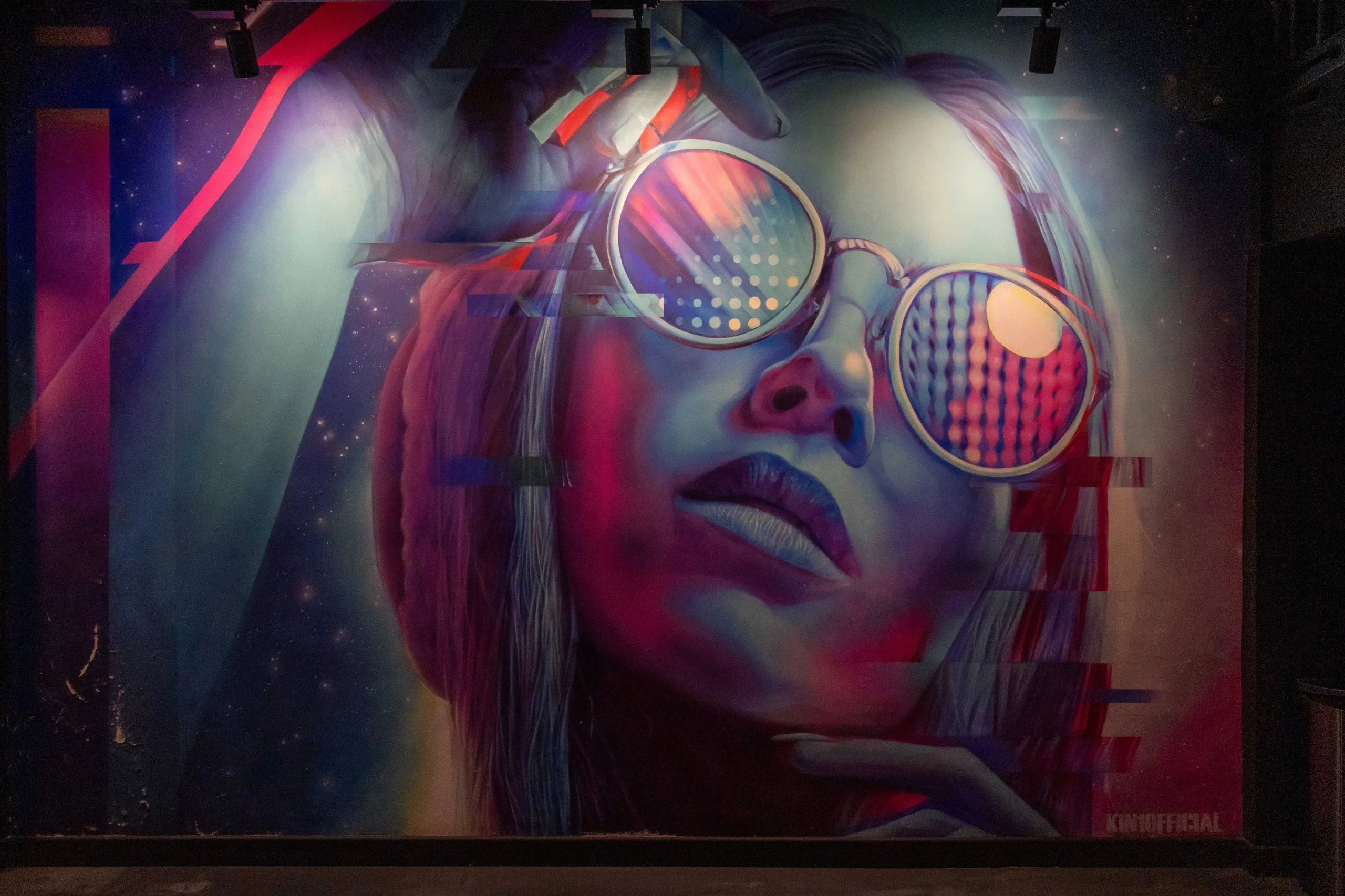 Wide view of colourful glitch-art mural and branded Luxe Fitness signage inside Bristol gym